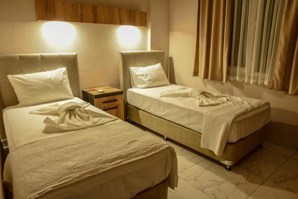 Postel nebo postele na pokoji v ubytování İRBEÇ APART & BUNGALOW