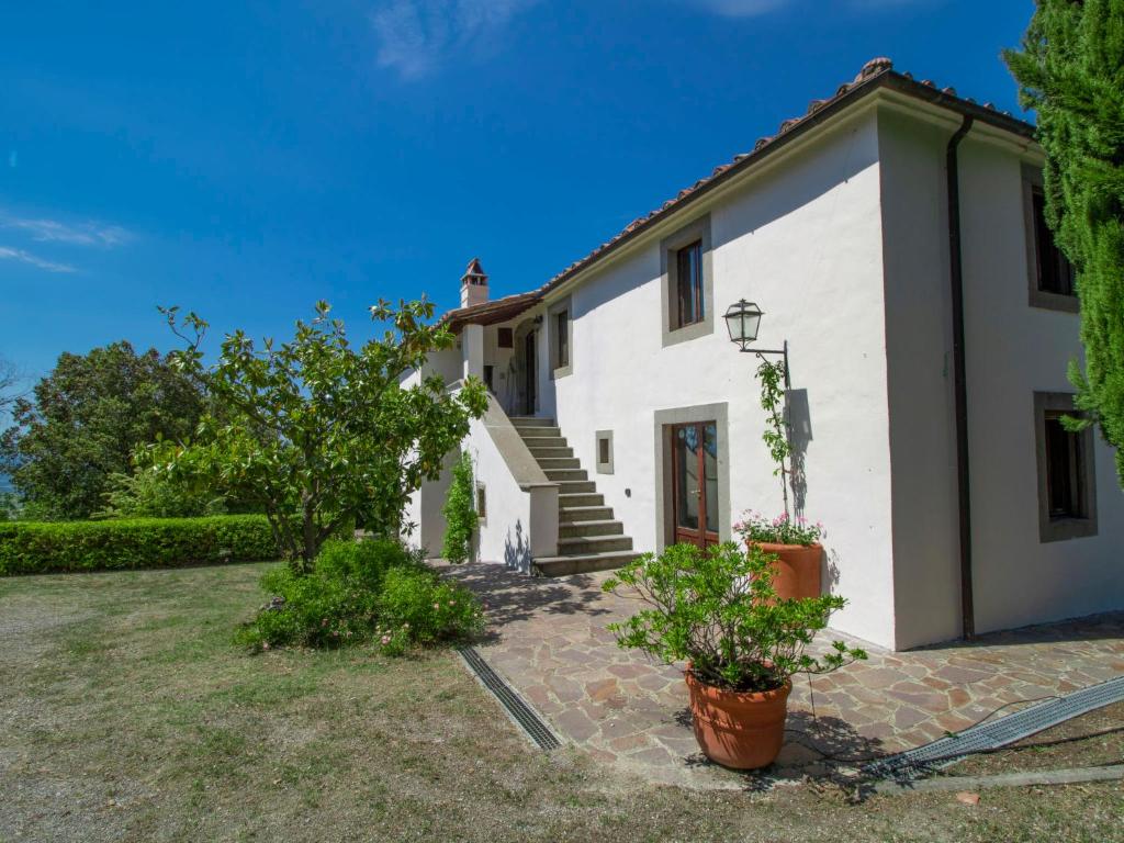 a white house with a staircase and a yard at Villa Gaia by Interhome in Poggio Ferro