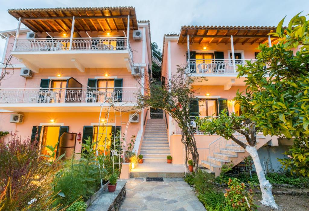 a pink house with stairs in front of it at Villa Maria Makri in Paleokastritsa