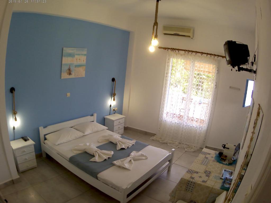 Postel nebo postele na pokoji v ubytování Apanemia Rooms