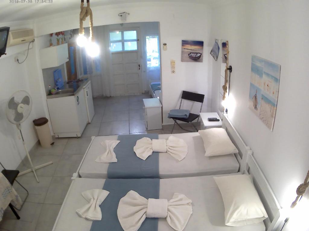 Postel nebo postele na pokoji v ubytování Apanemia Rooms