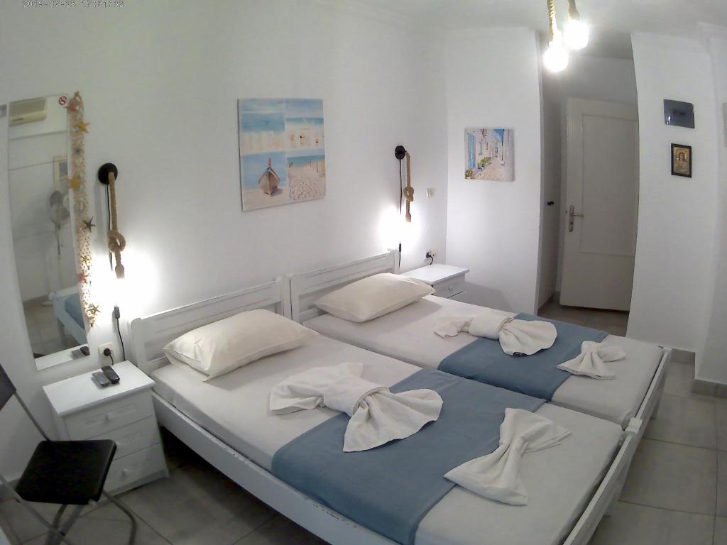 Postel nebo postele na pokoji v ubytování Apanemia Rooms