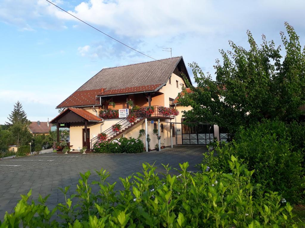a building with a gate in front of it at Family Puškarić in Slunj
