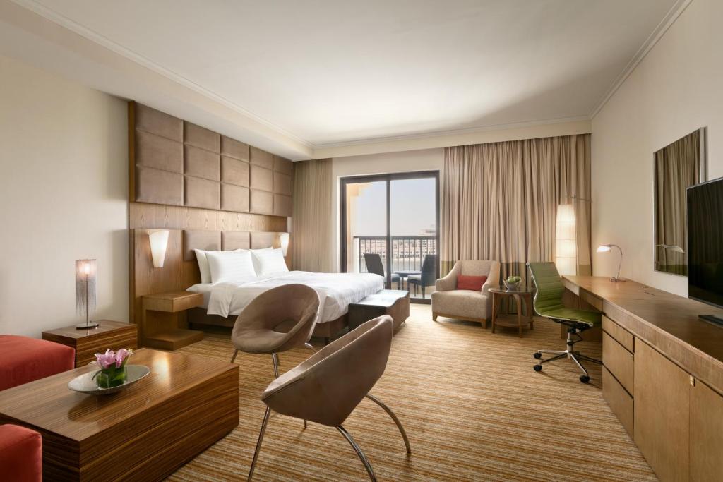 a hotel room with a bed and a television at Traders Hotel, Abu Dhabi in Abu Dhabi