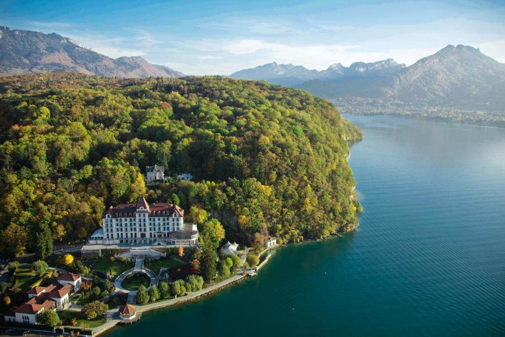 an aerial view of a building on a island in a lake at Le Palace De Menthon in Menthon-Saint-Bernard