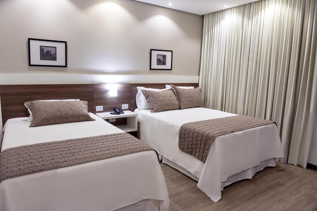 Кровать или кровати в номере Villas Hotel
