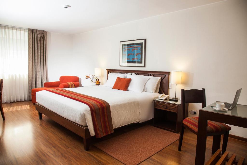 Un pat sau paturi într-o cameră la San Agustin Exclusive