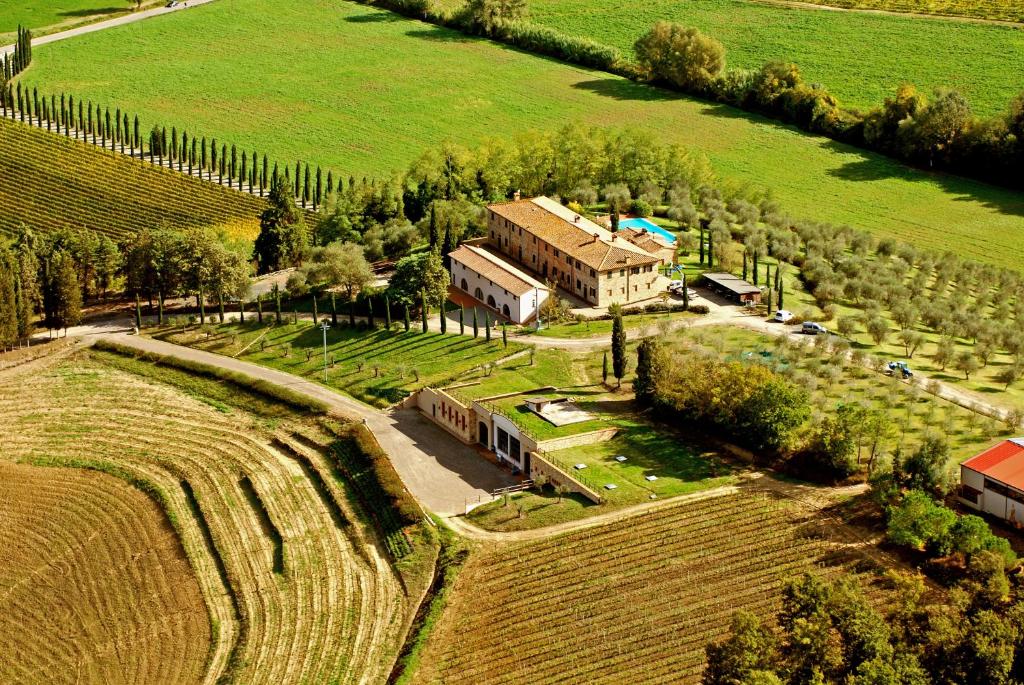 an aerial view of a house in a field at Fattoria Fibbiano in Terricciola