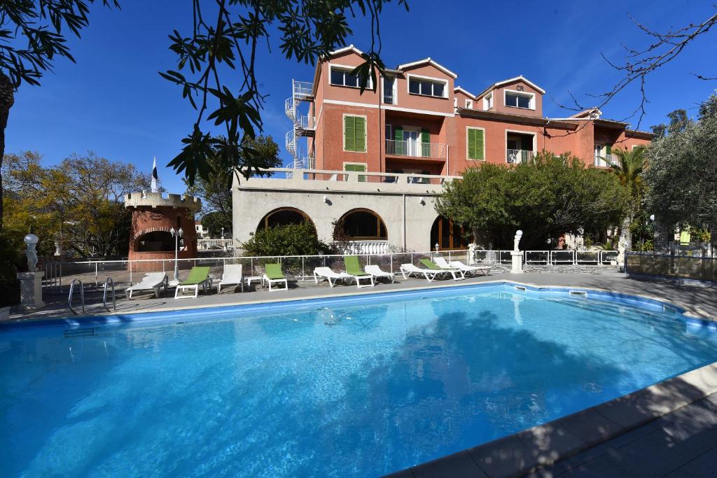 a swimming pool in front of a house at Castellu Rossu in Lucciana