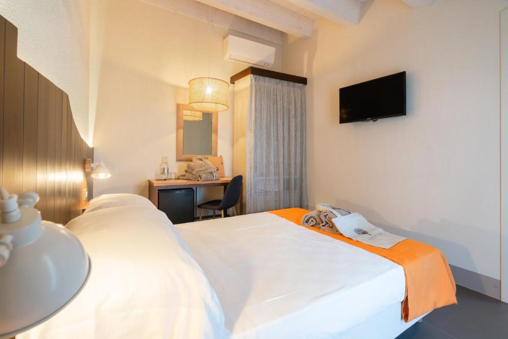 Posteľ alebo postele v izbe v ubytovaní Podere Maremma Spa & Ristorante