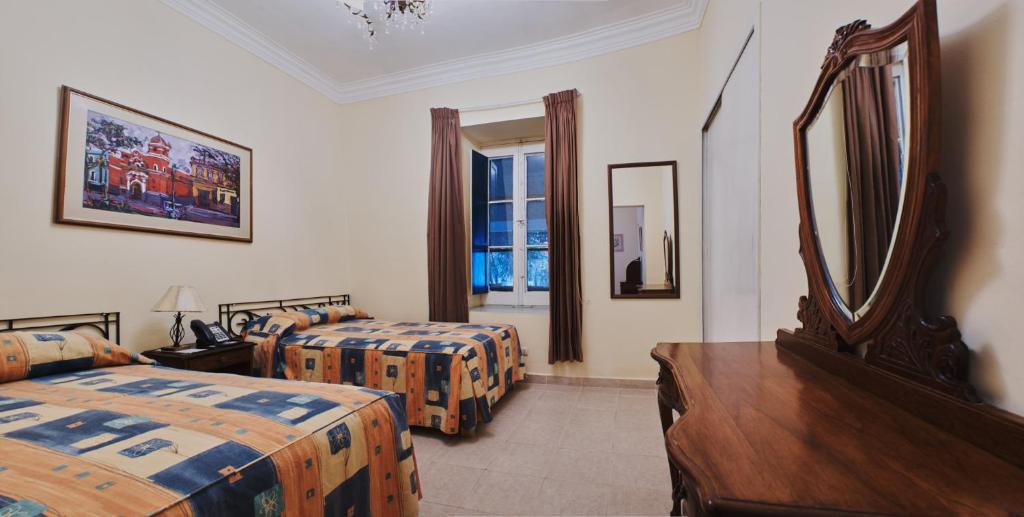 Postel nebo postele na pokoji v ubytování Hotel Majoro