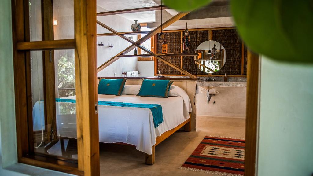 Postel nebo postele na pokoji v ubytování Hotel Poc Na Tulum