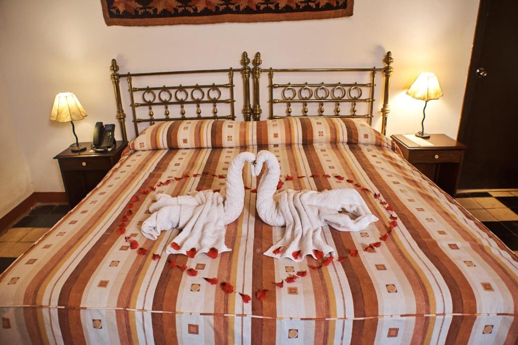 Postel nebo postele na pokoji v ubytování Hotel Majoro