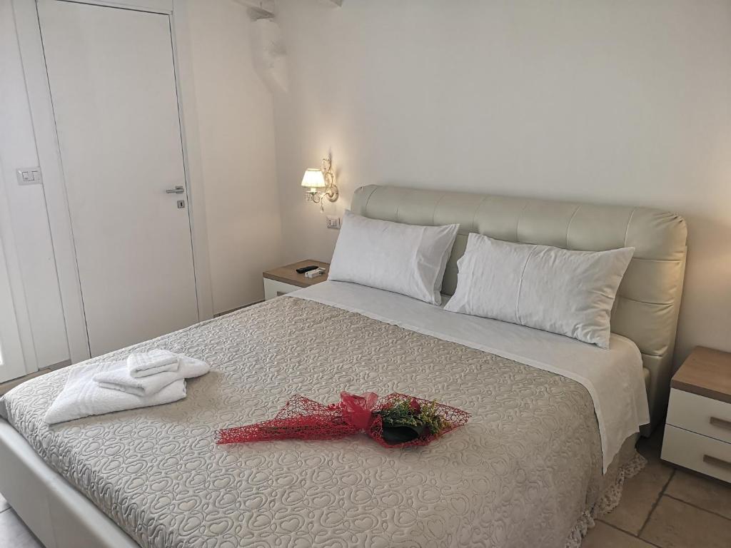 a bedroom with a bed with a red ribbon on it at B & B San Giovanni 9 in Gallipoli