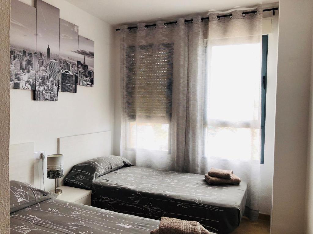 Кровать или кровати в номере Apartamento Arosa Playa