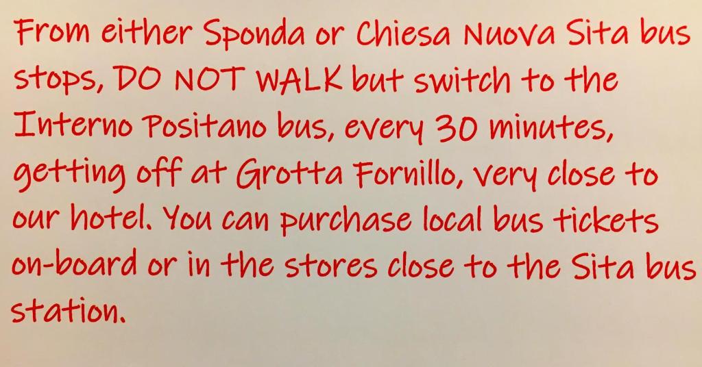 a handwritten letter with red handwriting on a white paper at Hotel Villa Delle Palme in Positano in Positano