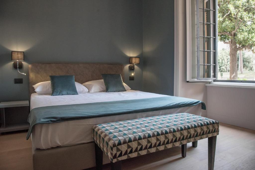 a bedroom with a large bed and a window at Domus Alberico in Rome