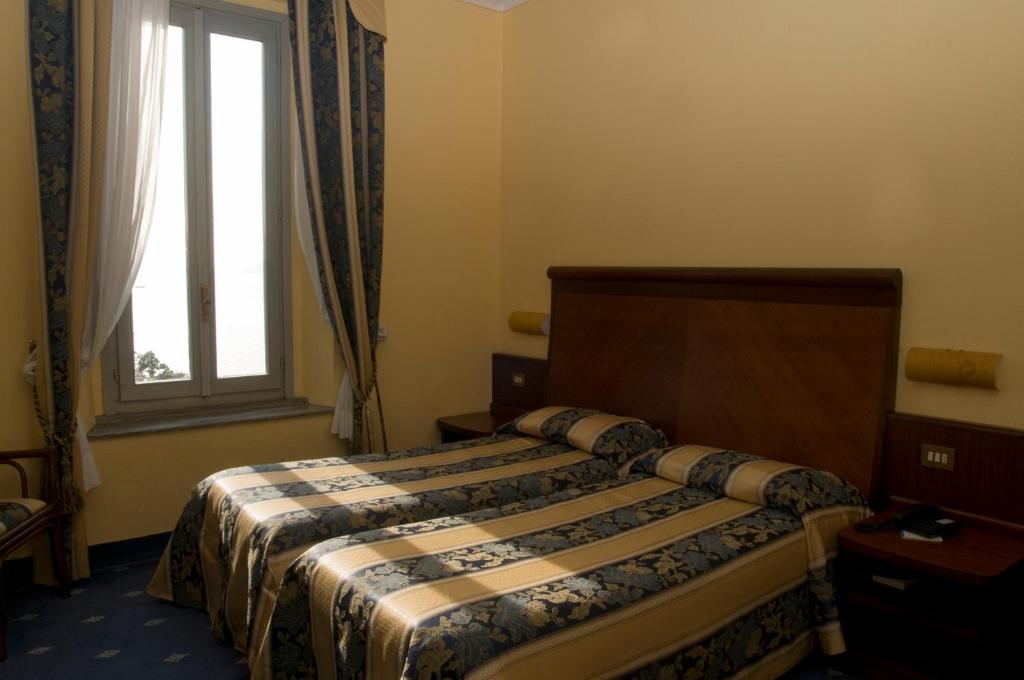 Postel nebo postele na pokoji v ubytování Europalace Hotel