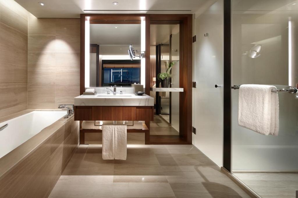 a bathroom with a sink and a tub and a mirror at The Shilla Seoul in Seoul
