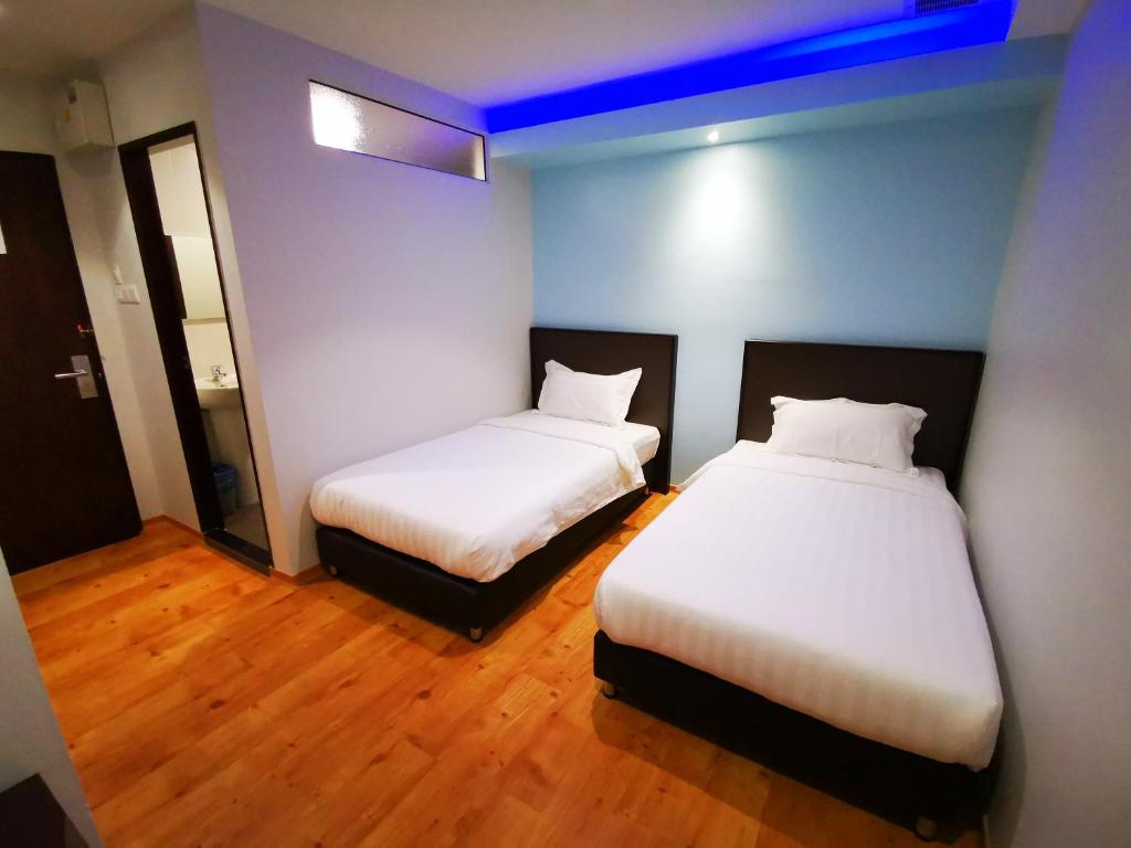Postel nebo postele na pokoji v ubytování D'Green Hotel Kuching