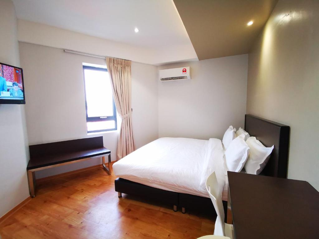 Postel nebo postele na pokoji v ubytování D'Green Hotel Kuching