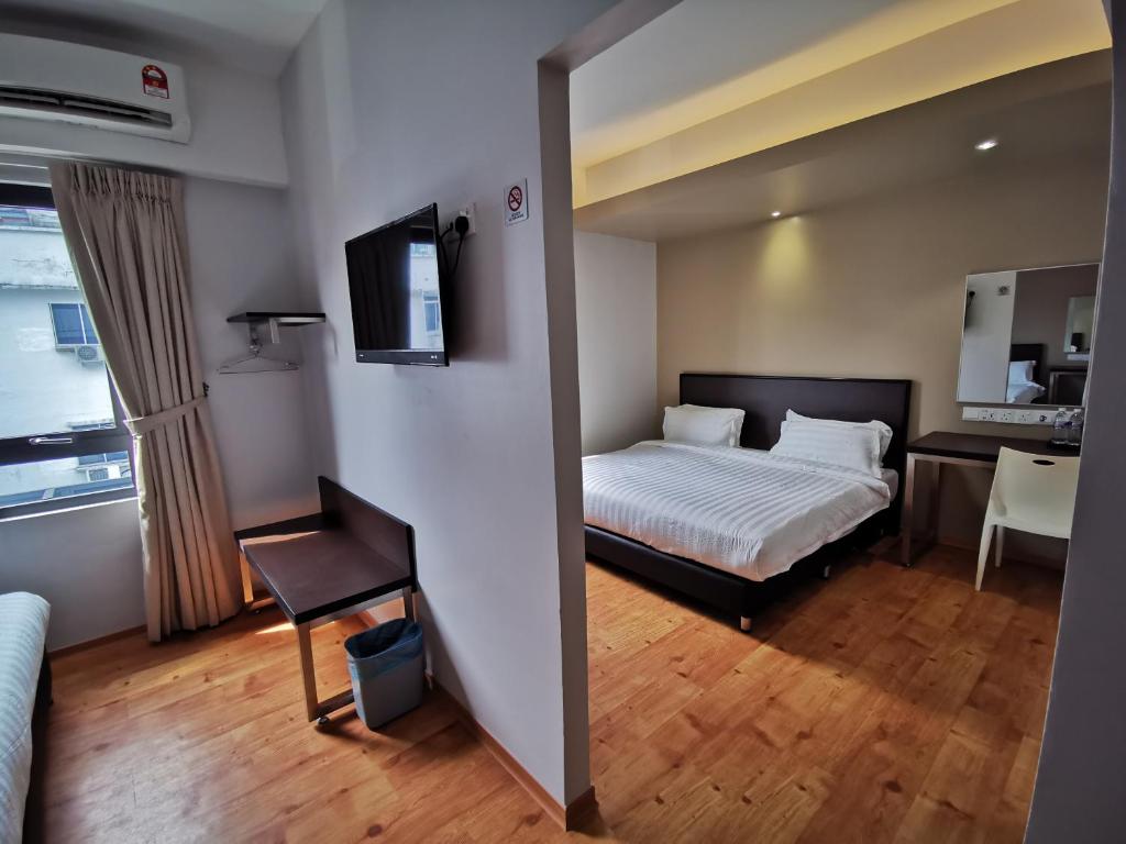Postel nebo postele na pokoji v ubytování D'Green Hotel Kuching