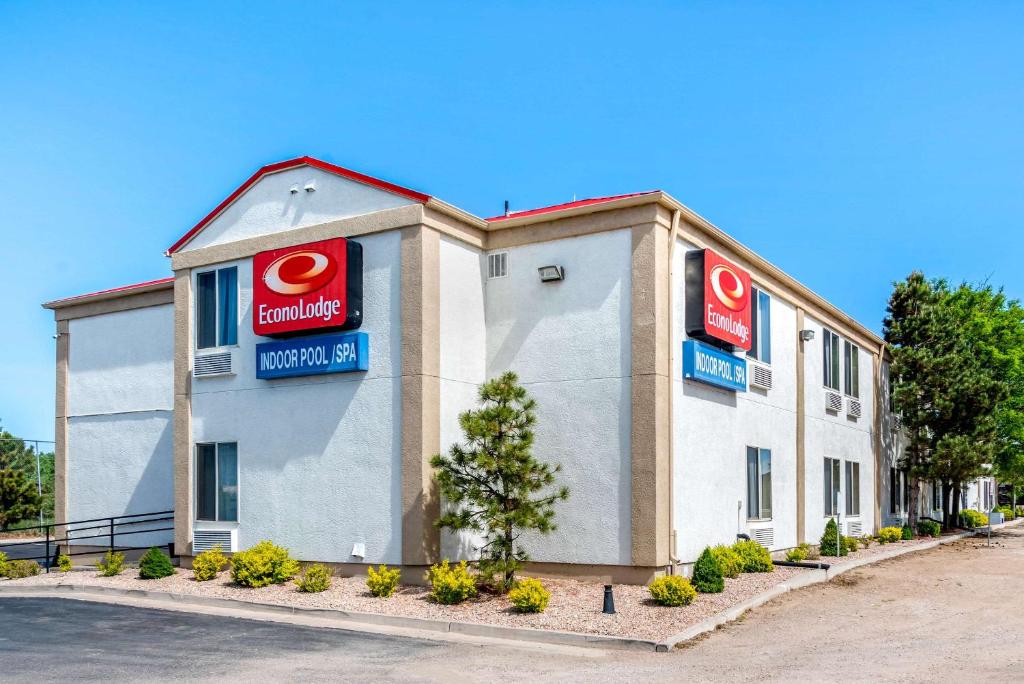 a building with two krispy kreme signs on it at Econo Lodge Airport/Colorado Springs in Colorado Springs