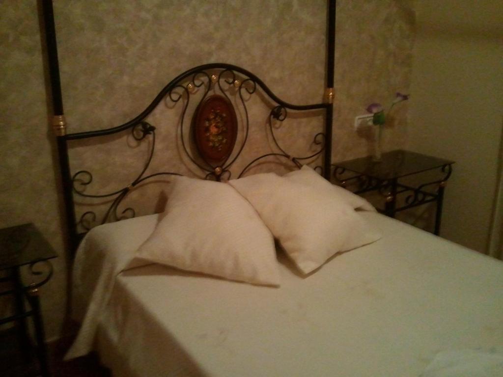 a bed with a white bedspread and pillows at Ca L´Ángels in Prat de Compte