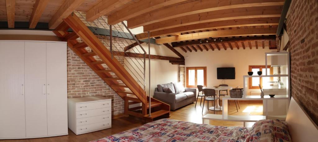 a bedroom with a bed and a staircase in a room at Loft Mirano Due (Alloggi alla Campana) in Mirano