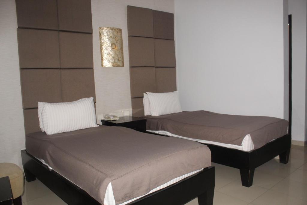 Postel nebo postele na pokoji v ubytování The Radiant Hotel