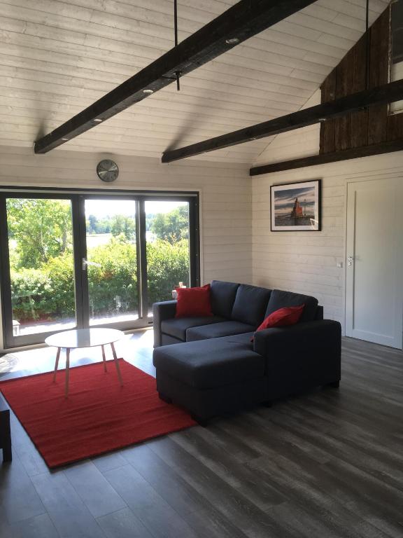 a living room with a couch and a red rug at kirsikkaranta in Pargas