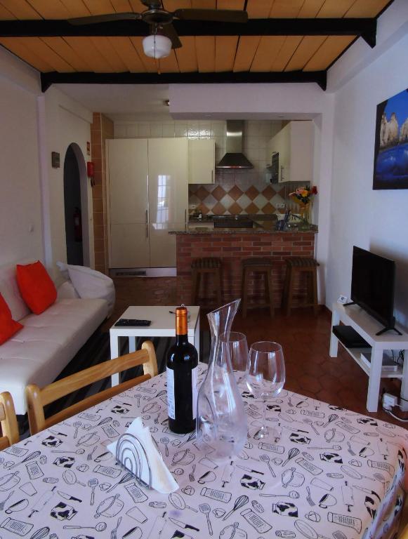 a table with a bottle of wine on top of it at Cantinho Das Estrelas, Luz Lagos in Luz