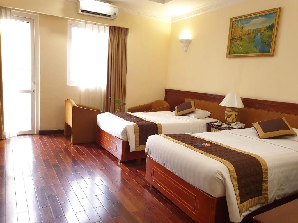 Postel nebo postele na pokoji v ubytování Huong Sen Hotel