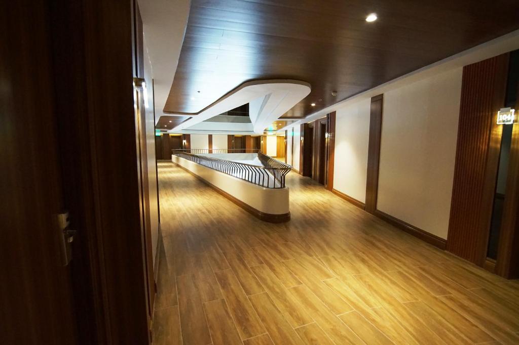 a hallway in a building with a wooden floor at Central Park Reef Resort in Olongapo