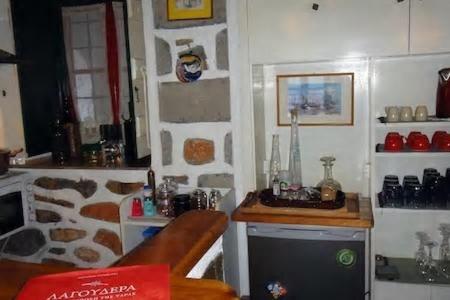 a kitchen with a stove and a counter top at Tramontana in Hydra