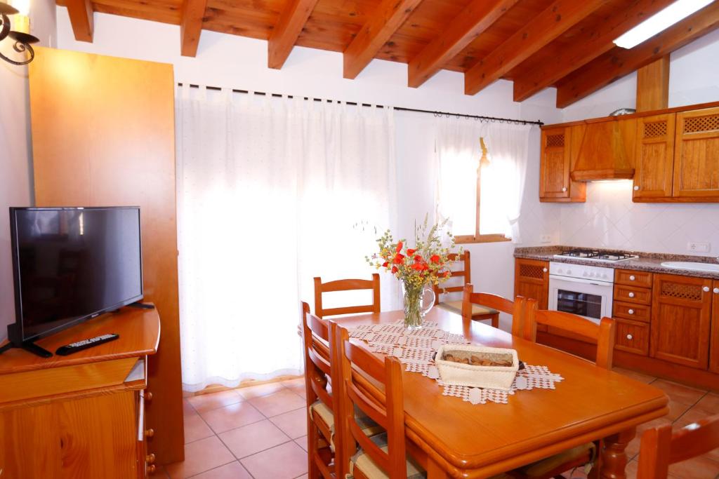 uma cozinha e sala de jantar com uma mesa e uma televisão em Casa Enpiera III - Turistrat em Cinctorres