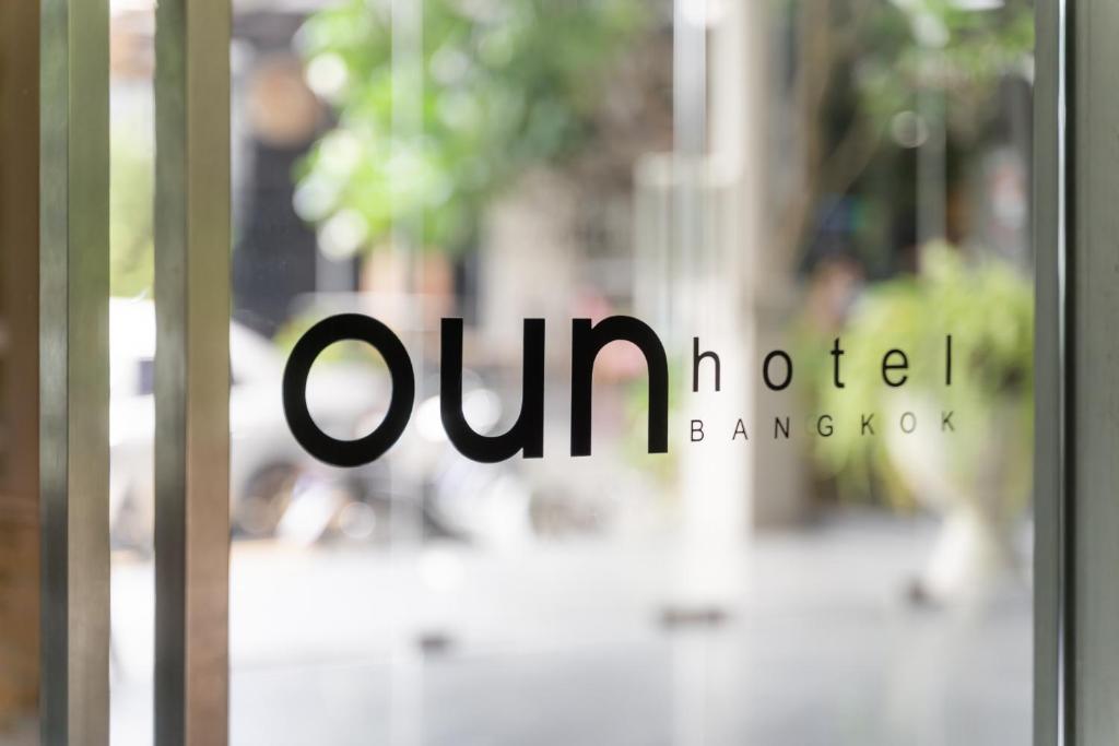a glass door with the wordunlisted on it at Oun Hotel Bangkok in Bangkok