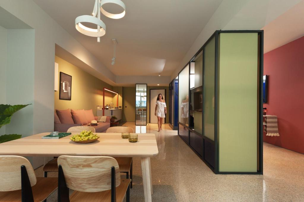 a dining room and living room with a table at Arcade Project Hi-end Apartments in Athens