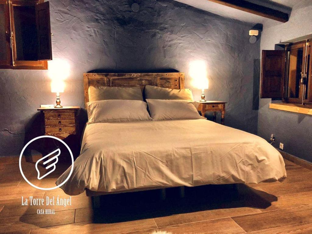 A bed or beds in a room at La Torre Del Angel Casa Rural