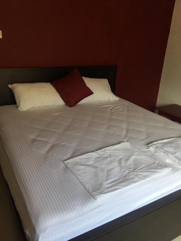Postel nebo postele na pokoji v ubytování Nallur Residence