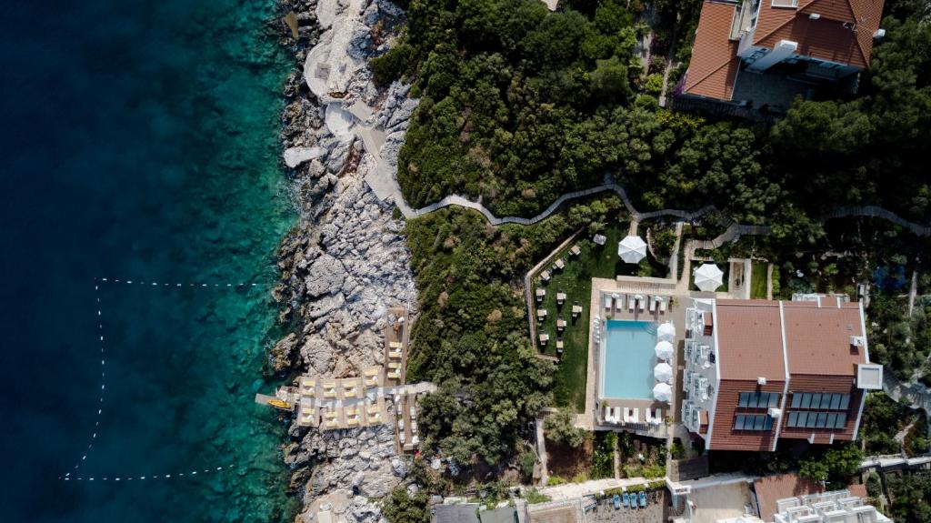 an aerial view of a resort next to the ocean at Suna Sun Hotel - Adult Only in Kaş