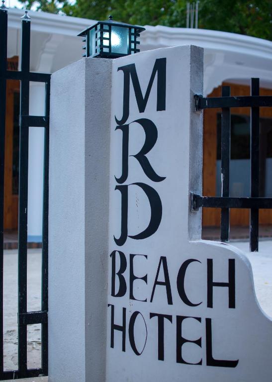 a sign for a beach hotel on a gate at MRD Beach Hotel in Trincomalee