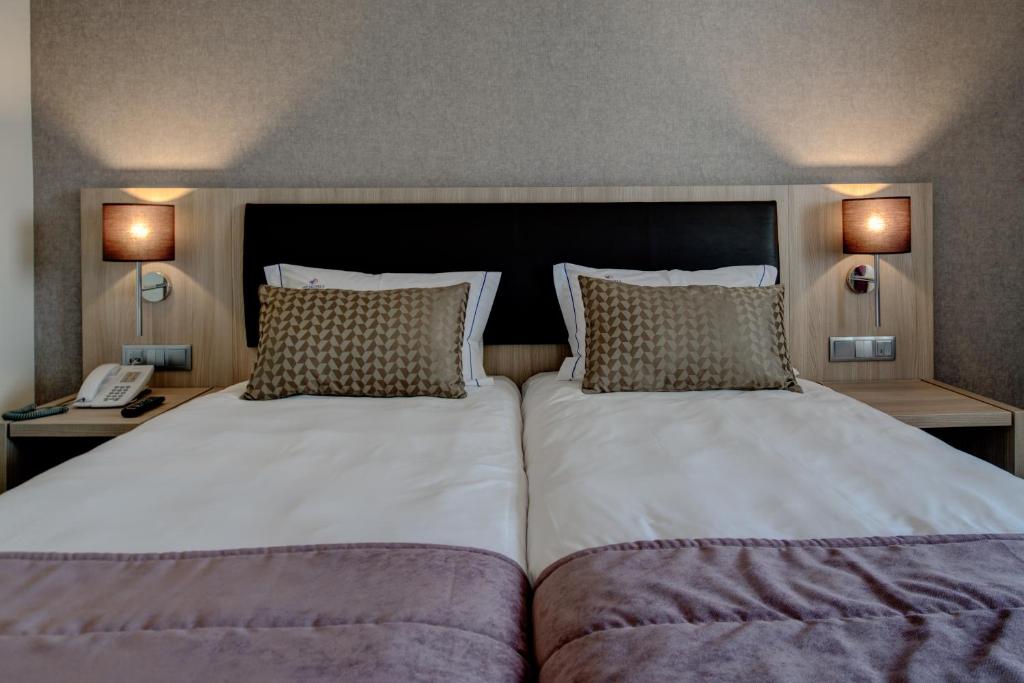 Uma cama ou camas num quarto em VIP Inn Berna Hotel