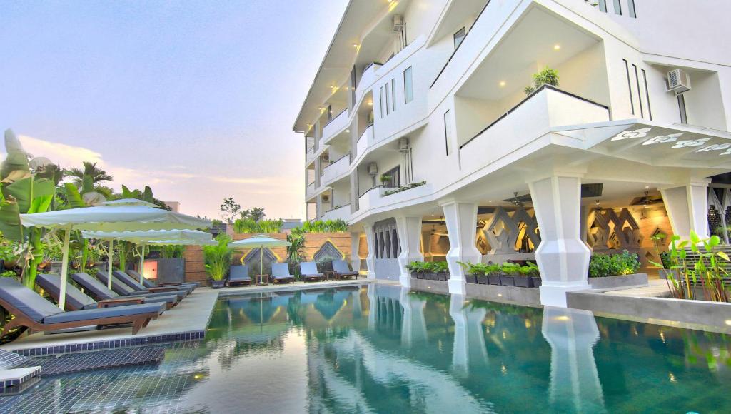 an exterior view of a hotel with a swimming pool at Central Suite Residence in Siem Reap
