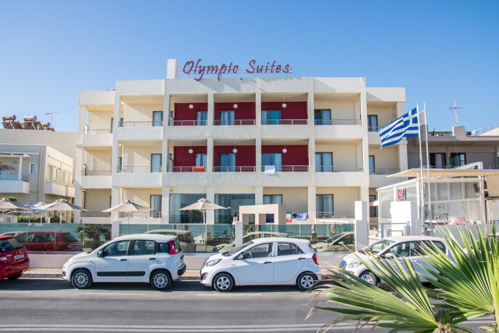 a group of cars parked in front of a building at Olympic Suites in Rethymno