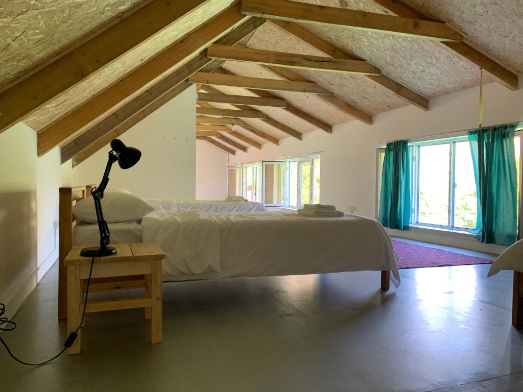 a bedroom with a bed and a lamp on a table at Gomkers Guest House in Gomkʼ