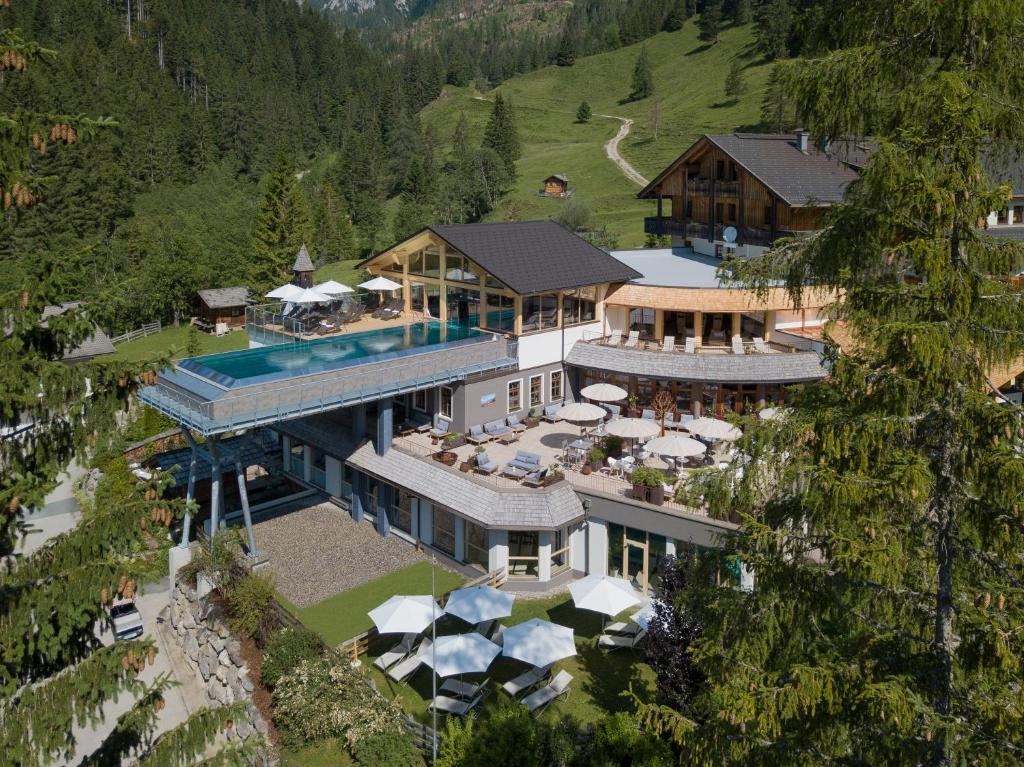 an aerial view of a house with a swimming pool at Almwellness-Resort Tuffbad in Sankt Lorenzen im Lesachtal