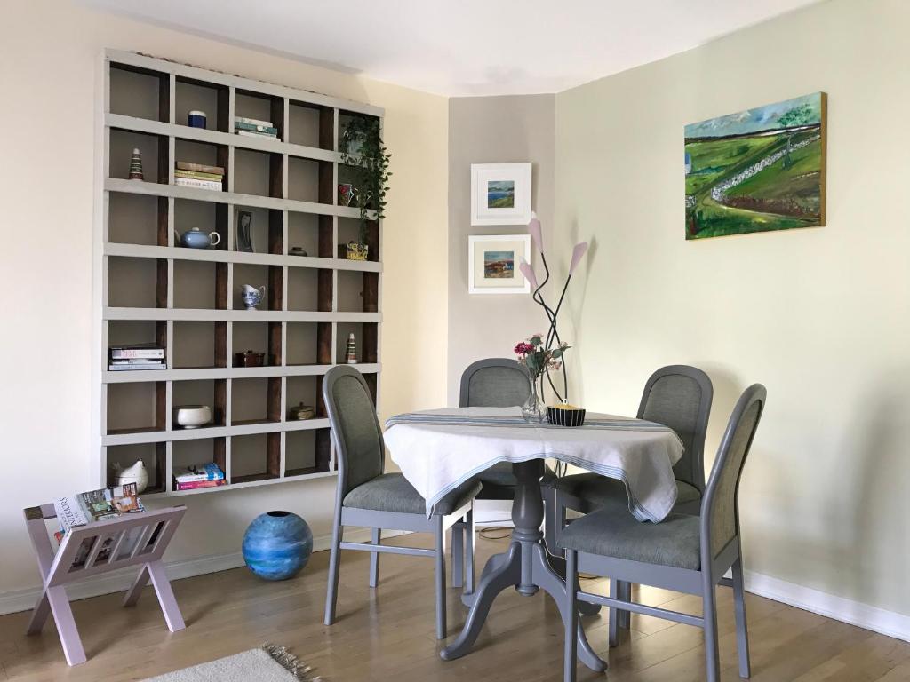 a dining room with a table and chairs at Sea Breeze in Bangor