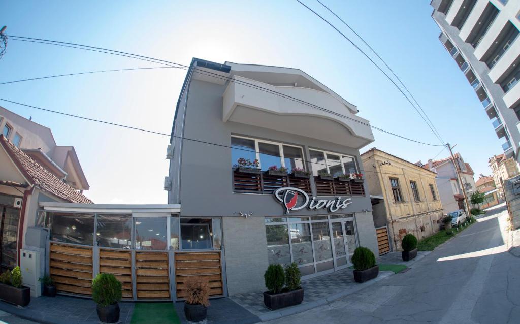 a building with a duke sign on the side of it at DIONIS Rooms &amp; Apartments in Prilep
