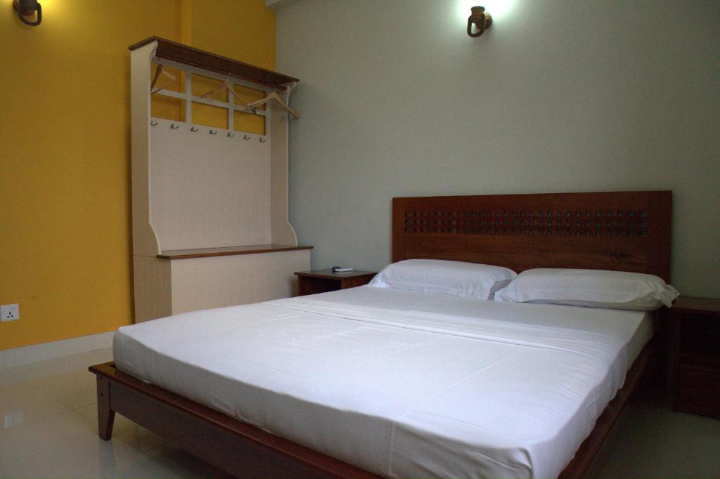 Postel nebo postele na pokoji v ubytování Lafala Hotel & Service Apartment